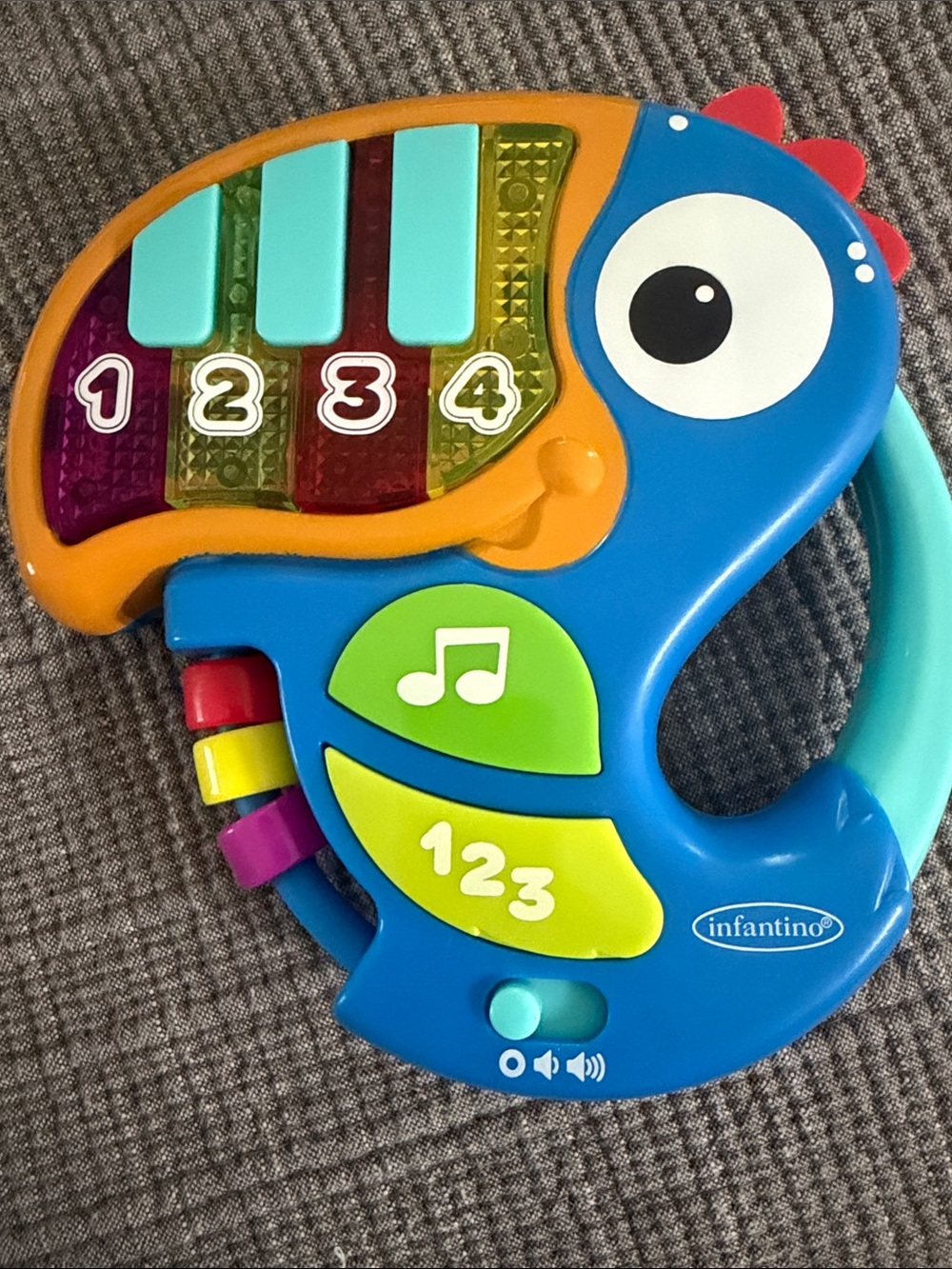 Infantino Blue Parrot Musical Learning Toy with Teal Keys & Yellow Accents